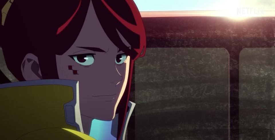 An anime-animated woman with red hair stands in front of a sunrise.