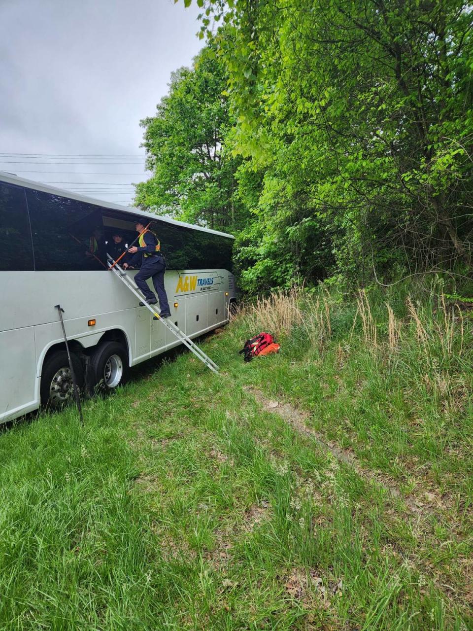 A first responder frees students and staff trapped in a bus off Interstate 85 in Gastonia. The bus was involved in a crash with another bus while both were traveling to Carowinds on Friday morning, April 26, 2024, police said. GASTONIA POLICE DEPARTMENT