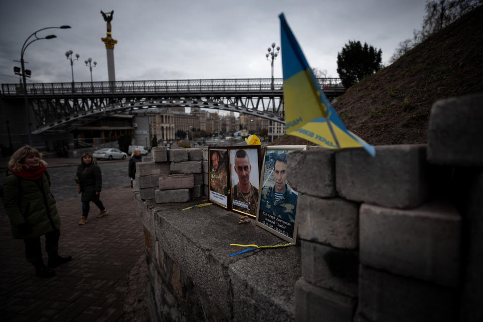 A women looks at the photos of protesters who were killed during the Euromaidan revolution at the memorial of "Heavenly 100" at Independence square in Kiev, Ukraine on October 28, 2019. (Photo: Agron Dragaj for Yahoo News) 