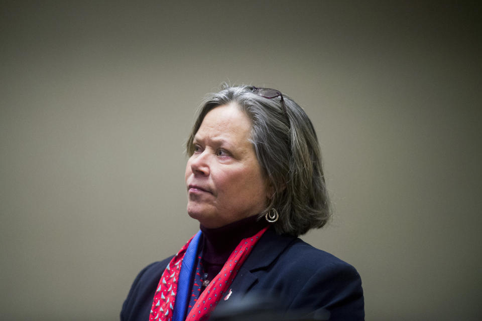 Dr. Eden Wells, Michigan's chief medical executive, stands in court Friday, Dec. 7, 2018, at Genesee District Court in downtown Flint, Mich. Wells will stand trial on involuntary manslaughter and other charges in a criminal investigation of the Flint water crisis, a judge ruled Friday. (Jake May/The Flint Journal via AP)