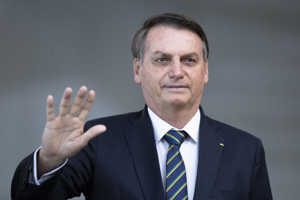 Brazil's President Jair Bolsonaro greets the media prior to a meeting of leaders of the BRICS emerging economies at the Itamaraty palace in Brasilia, Brazil, Thursday, Nov. 14, 2019. (AP Photo/Pavel Golovkin, Pool)