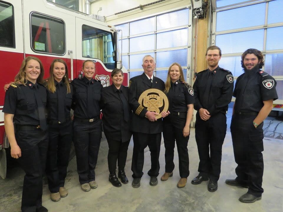 Pat Rowe, middle, receiving his Fort Simpson Volunteer Fire Department long service award.
