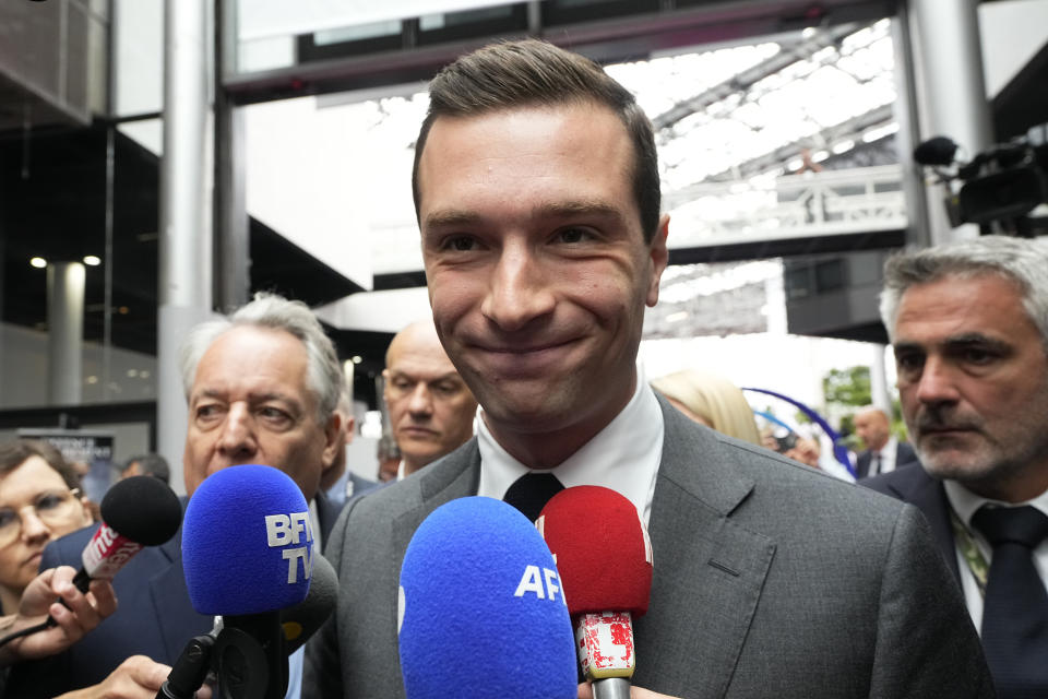 Jordan Bardella, president of the far-right National Front party, arrives at the Eurosatory Defense and security exhibition, Wednesday, June 19, 2024 in Villepinte, north of Paris. Jordan Bardella, the National Rally president hoping to become France's prime minister, appealed Tuesday to voters to hand his party a clear majority after French President Emmanuel Macron's announcement on June 9 that he was dissolving France's National Assembly, parliament's lower house.( AP Photo/Michel Euler)