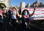 Anti-government demonstrators gesture during a protest as Lebanese mark one year since the start of nation-wide protests in Beirut