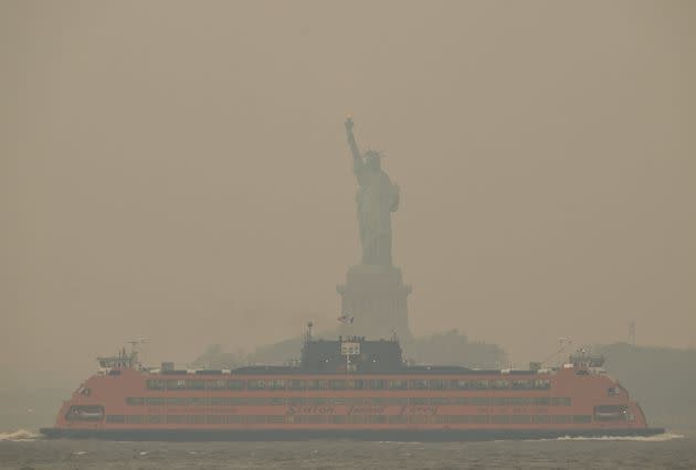 The Downtown Manhattan skyline stands shrouded in a reddish haze as a result of Canadian wildfires on Tuesday. 