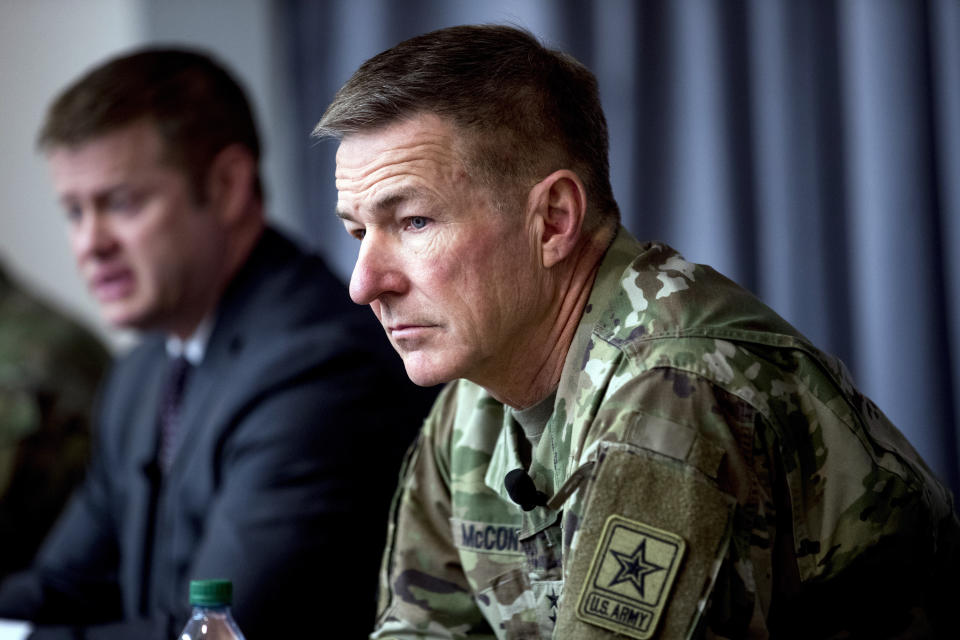 FILE - In this March 19, 2020, file photo Secretary of the Army Ryan McCarthy, left, accompanied by Gen. James McConville, Army chief of staff, right, speaks at a news conference at U.S. Army Medical Research and Development Command at Fort Detrick in Frederick, Md. Military suicides have increased by as much as 20% this year compared to the same period last year, and some incidents of violent behavior have spiked, as service members struggle with isolation and other impacts of COVID-19 added to the pressures of war-zone deployments and responding to national disasters and civil unrest. McConville said there's new attention to giving service members "the time that they need to come back together and recover.” (AP Photo/Andrew Harnik, File)