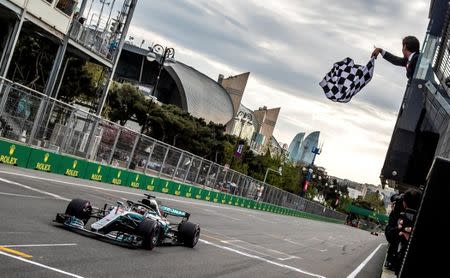 FILE PHOTO: Formula One - F1 - Azerbaijan Grand Prix - Baku City Circuit, Baku, Azerbaijan - April 29, 2018 Mercedes' Lewis Hamilton crosses the finish line to win the race Srdjan Suki/Pool via Reuters