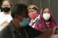 People wait in line at a free COVID-19 testing site provided by United Memorial Medical Center, Sunday, June 28, 2020, at the Mexican Consulate, in Houston. Confirmed cases of the coronavirus in Texas continue to surge. Texas Gov. Greg Abbott shut down bars again and scaled back restaurant dining on Friday as cases climbed to record levels after the state embarked on one of America's fastest reopenings. (AP Photo/David J. Phillip)