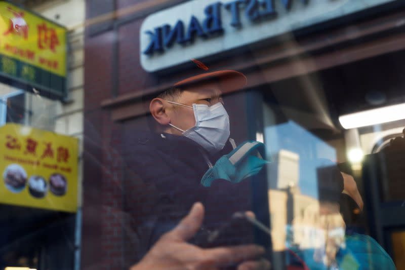 A man wears a face mask onboard a public bus in the Chinatown section of San Francisco