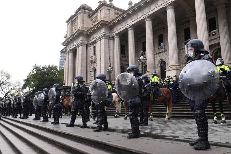 Riot police are seen outside the Victoria’s Parliament House during a protest by Construction, Forestry, Maritime, Mining and Energy Union (CFMEU) members in Melbourne.