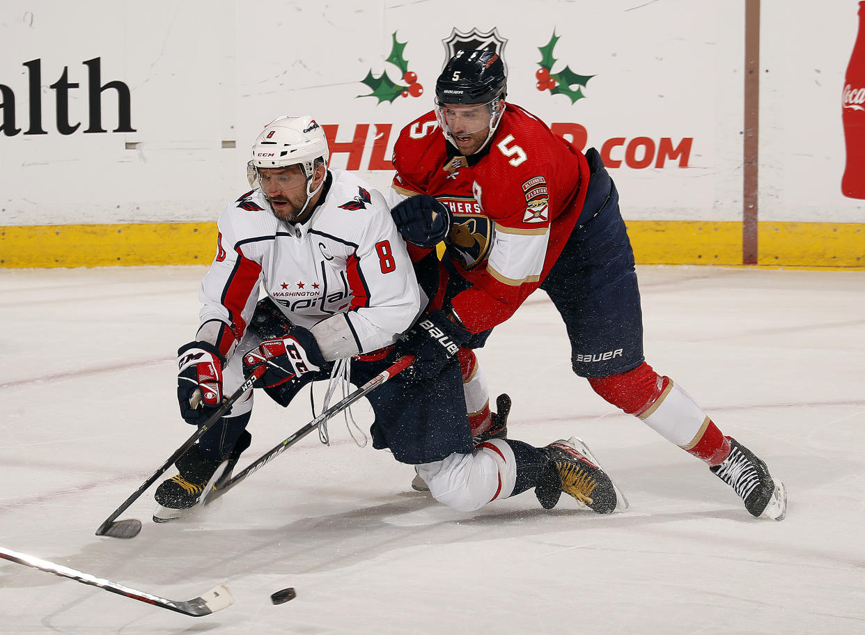 SUNRISE, FL - NOVEMBER 30: Aaron Ekblad #5 of the Florida Panthers battles with Alex Ovechkin #8 of the Washington Capitals at the FLA Live Arena on November 30, 2021 in Sunrise, Florida. (Photo by Eliot J. Schechter/NHLI via Getty Images)
