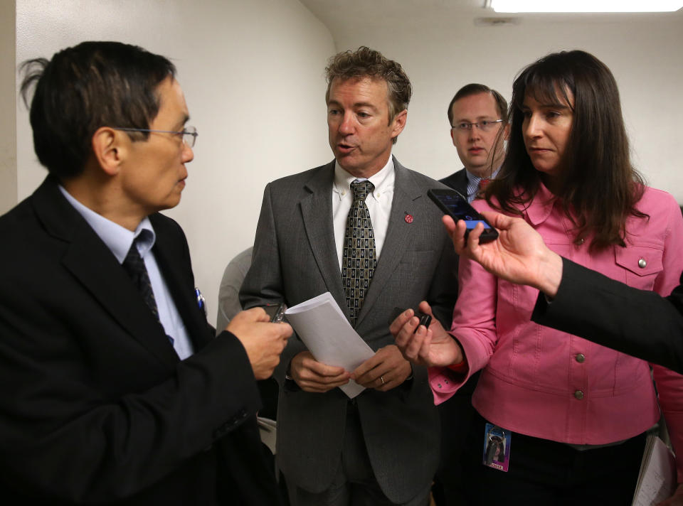 WASHINGTON, DC - JANUARY 07:  U.S. Sen. Rand Paul (R-KY) (2nd L) talks to reporters while walking to the Senate chamber to vote on unemployment insurance at the US Capitol January 7, 2014 in Washington, DC. The U.S. Senate voted 60-37 to move forward with a bill to extend federal unemployment benefits for three months.  (Photo by Mark Wilson/Getty Images)