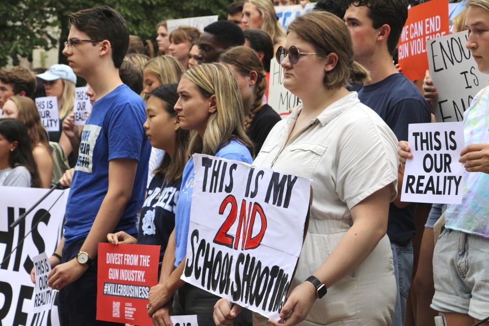 Students hold signs during a gun safety rally following a fatal shooting earlier in the week on the University of North Carolina at Chapel Hill campus, Wednesday, Aug. 30, 2023, in Chapel Hill, N.C. (AP Photo/Hannah Schoenbaum)