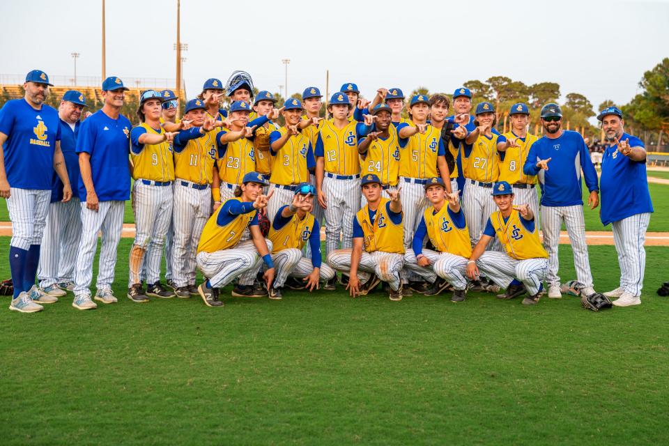 John Carroll Catholic poses for a post-game team photo after winning against Trinity Christian Academy in a high school baseball Region 4-2A semifinal Saturday, May 11, 2024, at the Lawnwood Baseball Complex in Fort Pierce.