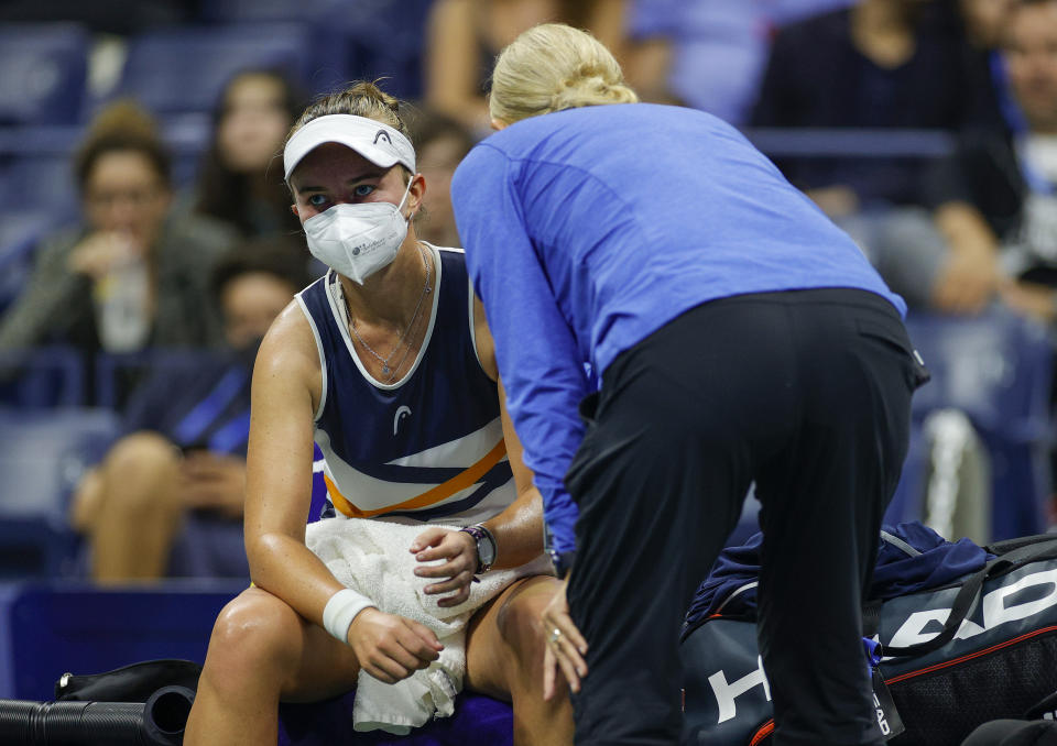 Barbora Krejcikova (pictured) talks with her trainer during her match against Garbine Muguruza at the US Open.