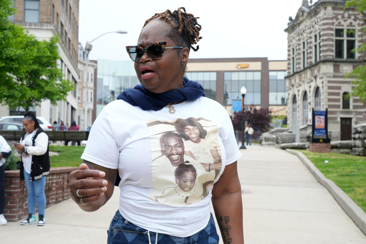 Wearing a t-shirt with a photo of her when she was a toddler with her father, Theodora Carter, the daughter of Ruben Hurricane Carter, the boxer who was wrongfully convicted of murder, attends the street naming ceremony for her father in front of the Passaic County Courthouse in Paterson, NJ on Monday May 6, 2024.