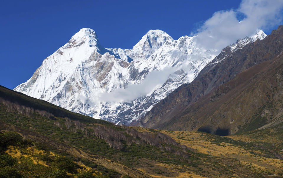 In this Oct. 7, 2016, photo provided by Juniper Outdoor Pursuits Centre Pvt. Ltd., shows Nanda Devi twin peaks, seen from Chaukori in Uttarakhand, India. Indian air force pilots have resumed a search over a Himalayan mountain for a team of mostly foreign climbers missing since late May. The fourth day of the search on Tuesday was taking place in the northern state of Uttarakhand after five bodies were spotted in the snow in high-resolution photos taken Monday. (Maninder Kohli/Juniper Outdoor Pursuits Centre Pvt. Ltd via AP)