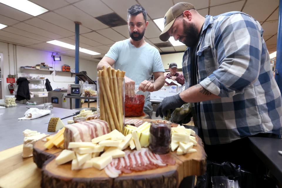 Paradox Charcuterie's Chef Jimmy Gentry and Charcutier Mitchell Marable prepare a board featuring house made jams, pickles, duck prosciutto and pate noisette, amongst a full spread created and cured at their shop on Thursday, January 13, 2022.