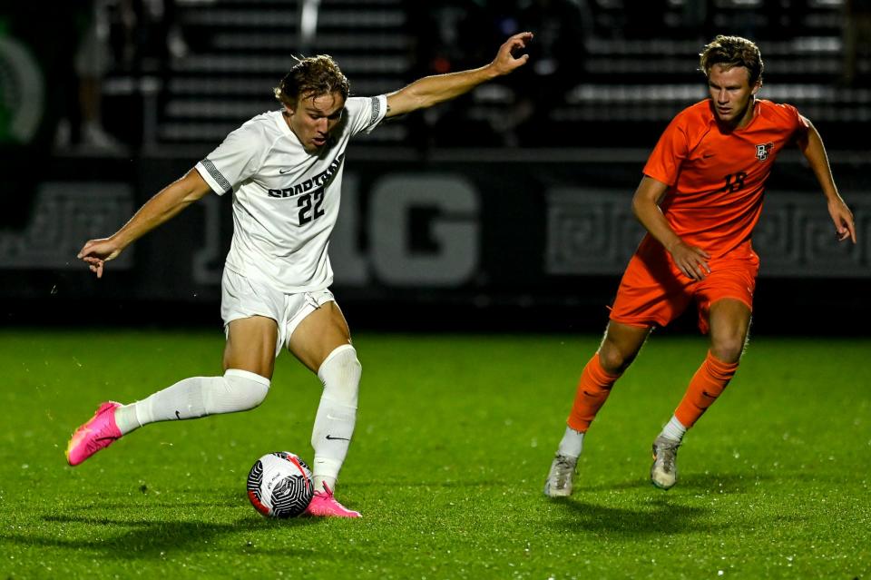 Michigan State's Jake Spadafora, left, kicks the ball as Bowling Green's Mads Christensen closes in during the second half on Monday, Aug. 28, 2023, at DeMartin Soccer Complex in East Lansing.