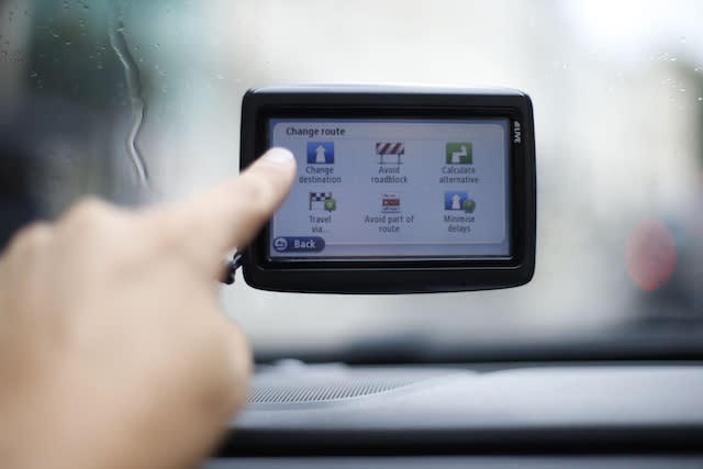 File photo dated 11/08/14 of a man using a satellite Navigator in his car, as motorists waste the equivalent of 29 hours every year using sat navs, according to a new study.