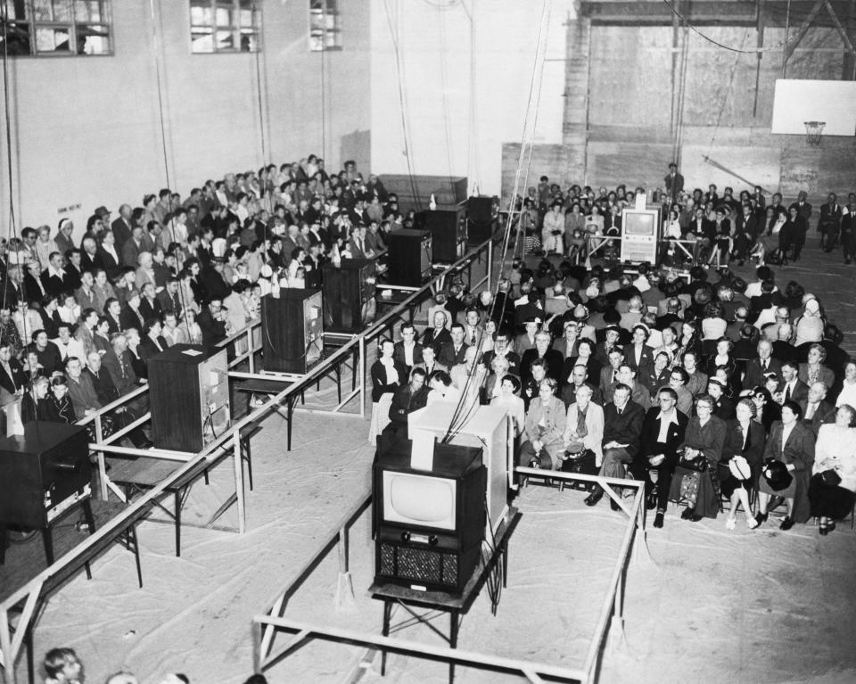 (Original Caption) 6/8/1953-Vancouver, Canada: This unique TV hook-up in Marpole Community Centre, Vancouver enabled over 1200 people to see the coronation as televised from London, June 2. Here, they sit engrossed as they watch part of the magnificent ceremonies crowning their new Queen Elizabeth II.