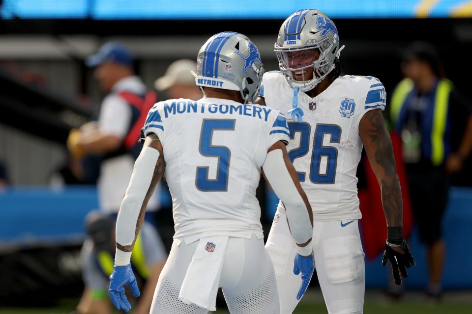 Jahmyr Gibbs of the Detroit Lions celebrates a touchdown with David Montgomery of the Detroit Lions during the first quarter against the Los Angeles Chargers at SoFi Stadium on November 12, 2023 in Inglewood, California.