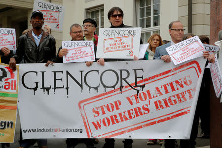 FILE PHOTO: Protesters display a banner and posters in front of the venue of commodities trader Glencore's annual shareholder meeting in Zug, Switzerland May 2, 2018. REUTERS/Arnd Wiegmann