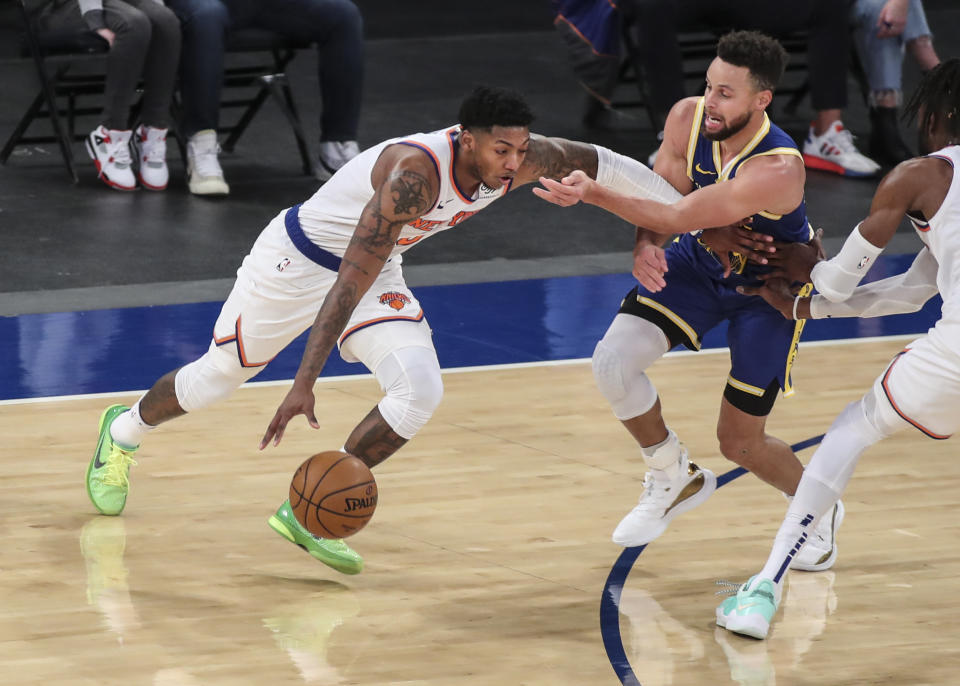 New York Knicks guard Elfrid Payton (6) moves past Golden State Warriors guard Stephen Curry during the second quarter of an NBA basketball game Tuesday, Feb. 23, 2021, in New York. (Wendell Cruz/Pool Photo via AP)
