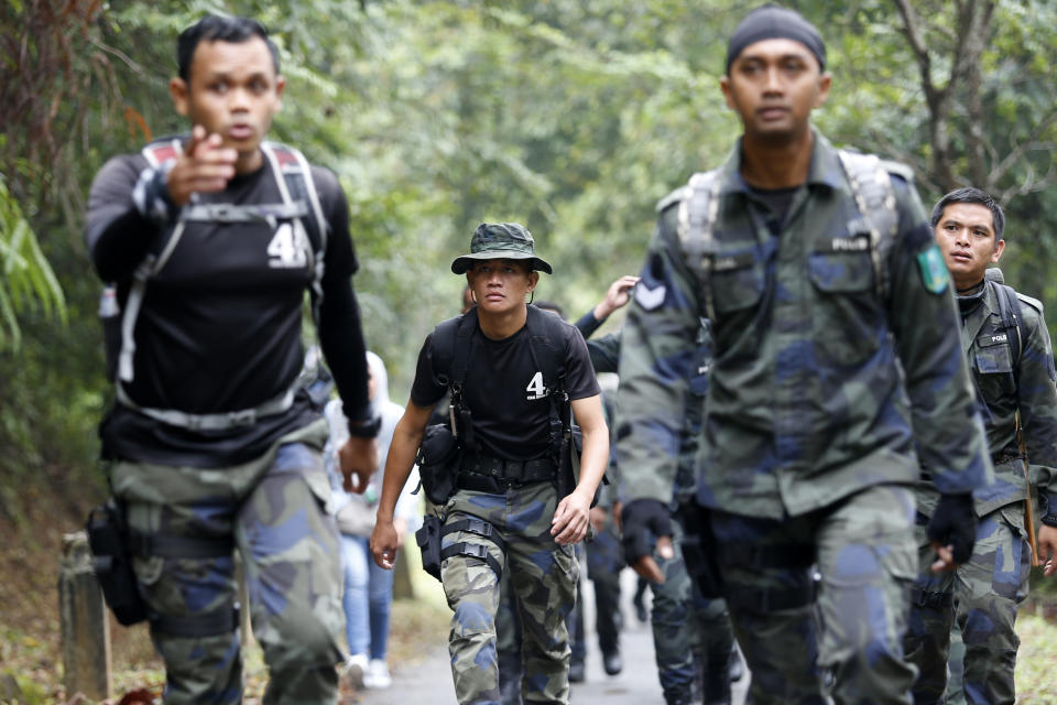 Members of a rescue team conduct a search and rescue operation for a missing British girl Nora Anne Quoirin, at a forest in Seremban, Negeri Sembilan, Malaysia, Saturday, Aug. 10, 2019. The parents of the 15-year-old London girl who disappeared from a Malaysian resort a week ago say she isn't independent and has difficulty walking, in new details to support their conviction that she was abducted. (AP Photo/Lai Seng Sin)