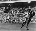 FILE - In this June 16, 1982 file photo England's Bryan Robson, left, heads the ball past French goalkeeper Jean Ettori, right, and defender Christian Lopez, to score his and England's second goal during the World Cup soccer match between England and France in Sam Manes Stadium, Bilbao. England defeated France 3-1. (AP Photo, File)