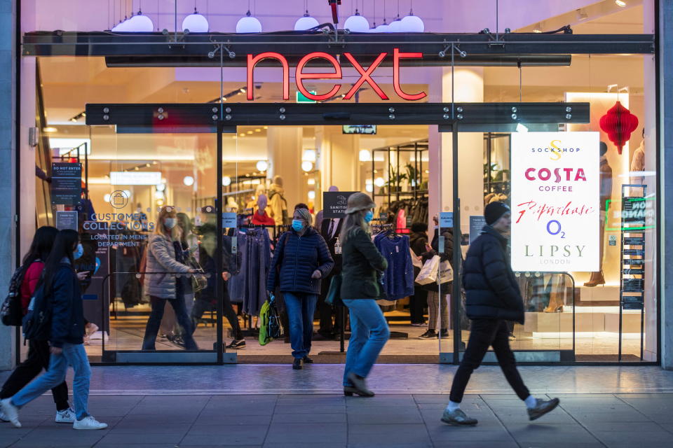 People walk past a store of clothing retailer Next in London, Britain, December 2, 2021. Picture taken December 2, 2021.   REUTERS/May James