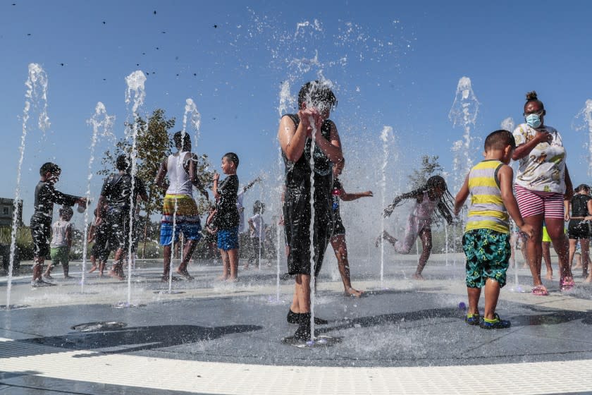 Los Angeles, CA, Monday, Sept. 6, 2021 - Children frolic in a playground water fountain at Earvin "Magic" Johnson Park. (Robert Gauthier/Los Angeles Times)