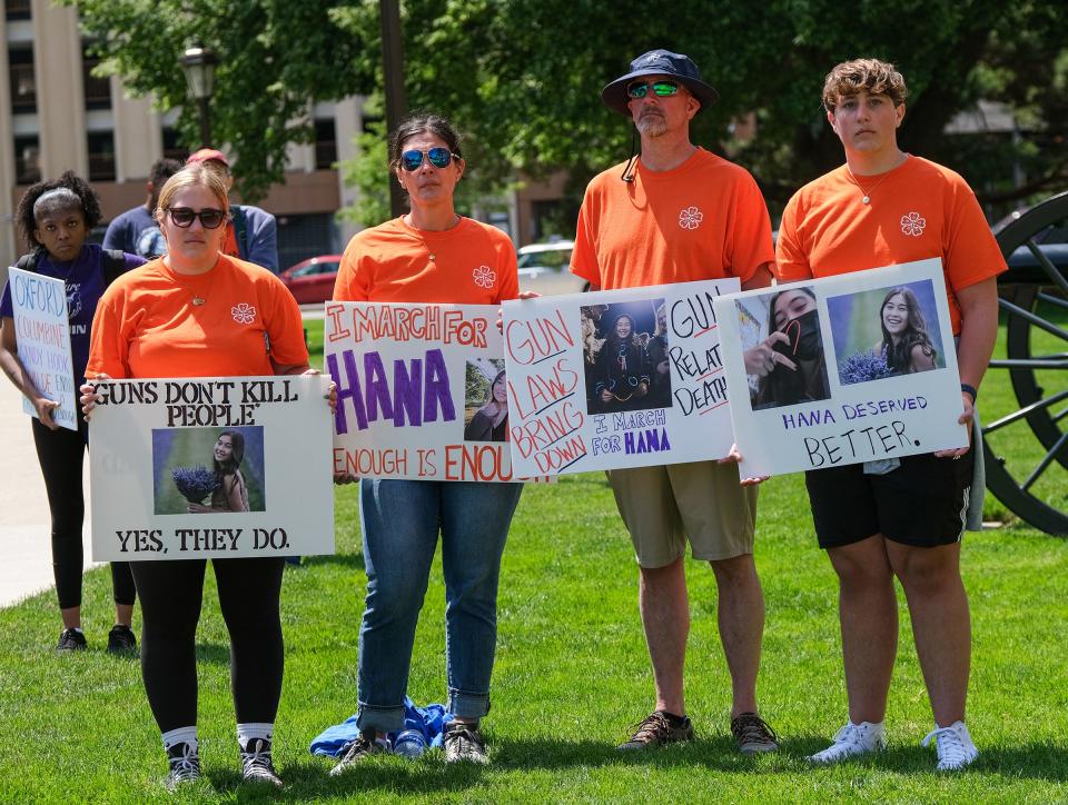 The Curtis family, from left, Olivia, Jennifer, Shannon and Jack, from Oxford, attended the March for Our Lives rally. They are holding up signs for their close friend, Hana St. Juliana, Saturday, June 11, 2022. Hana was killed in the mass shooting in Oxford.