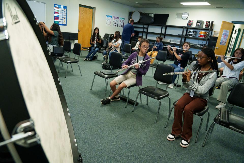 Carissa Cheong (front left) and Zhanyia Grant (front left) discuss their finger placement as they warm up on the flute in the band room at Alhambra Traditional School on Aug. 28, 2023, in Phoenix.