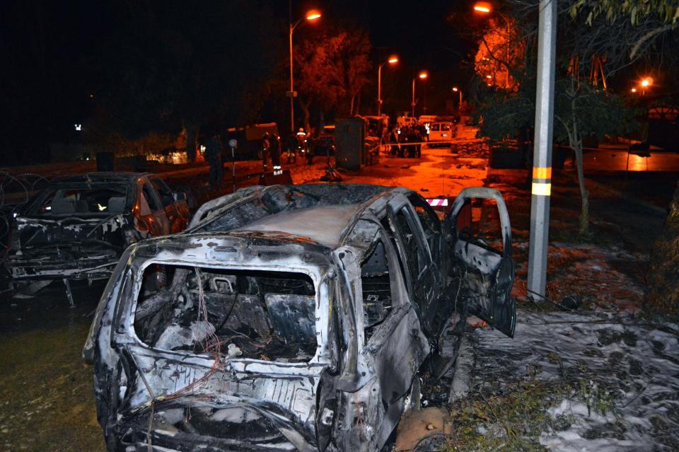 Burned and damaged cars are seen at the site of an explosion, in the predominately Shiite town of Hermel, about 10 miles (16 kilometers) from the Syrian border in northeast Lebanon, Saturday, Feb. 22, 2014. A suicide attacker blew himself up at an army checkpoint after troops tried to search his car Saturday, killing and wounding a number of people including soldiers in the latest blast linked to Syria's civil war, a senior military official and the state news agency said. (AP Photo)