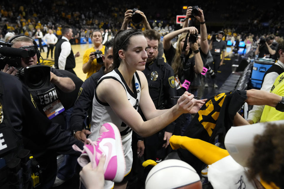 Iowa guard Caitlin Clark signs autographs after a second-round college basketball game against West Virginia in the NCAA Tournament, Monday, March 25, 2024, in Iowa City, Iowa. Iowa won 64-54. (AP Photo/Charlie Neibergall)