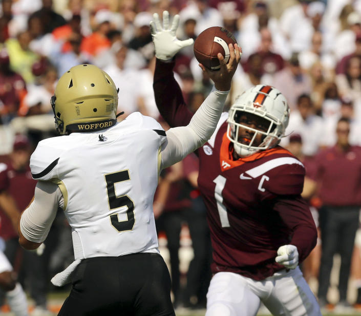 Wofford quarterback Jimmy Weirick (5) is pressured by Virginia Tech defensive back Chamarri Conner (1) during the first half of an NCAA college football game, Saturday, Sept. 17, 2022, in Blacksburg Va. . (Matt Gentry/The Roanoke Times via AP)
