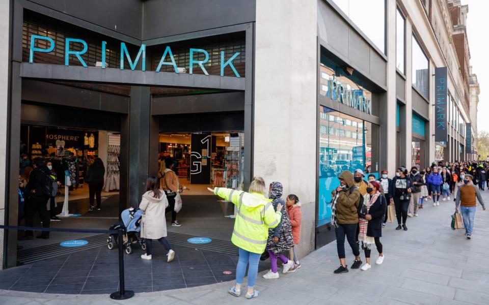 Shoppers queue outside Primark on Oxford Street in central London on Monday