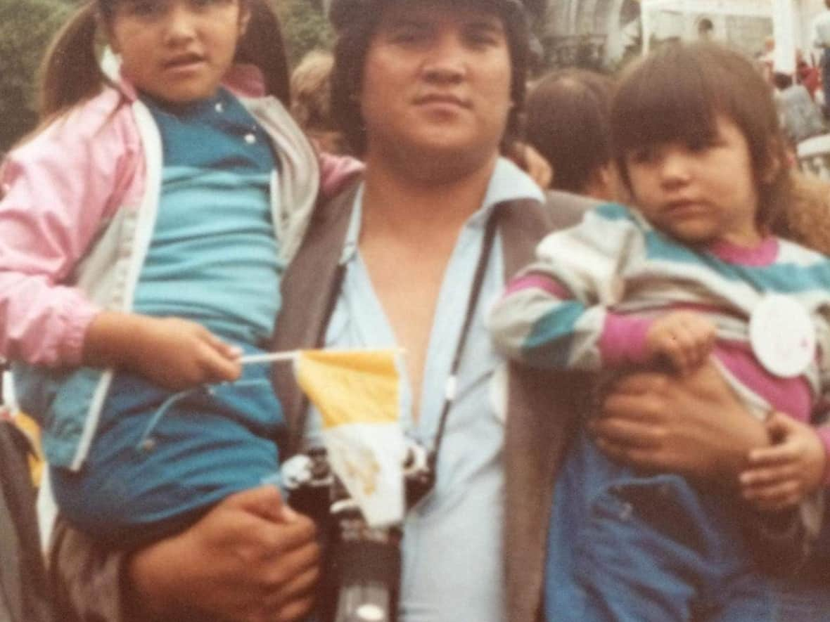 Glenda Sandy, left, with her father Sandy Robinson and her younger sister in 1984, when they went to Sainte-Anne-de-Beaupré, Que., to see Pope Jean-Paul II. (Submitted by Glenda Sandy - image credit)