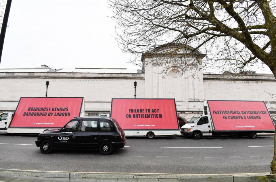 A convoy of three billboard advertising vans with an anti-semitism message for Jeremy Corbyn (PA)