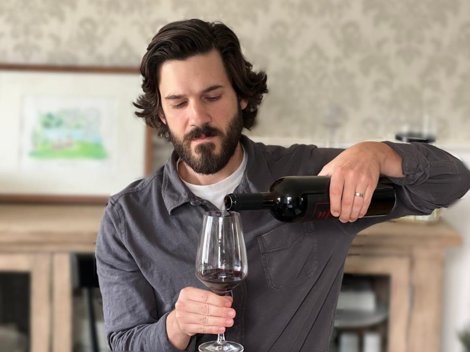 The author pours a glass of Three by Wade Cabernet Sauvignon.