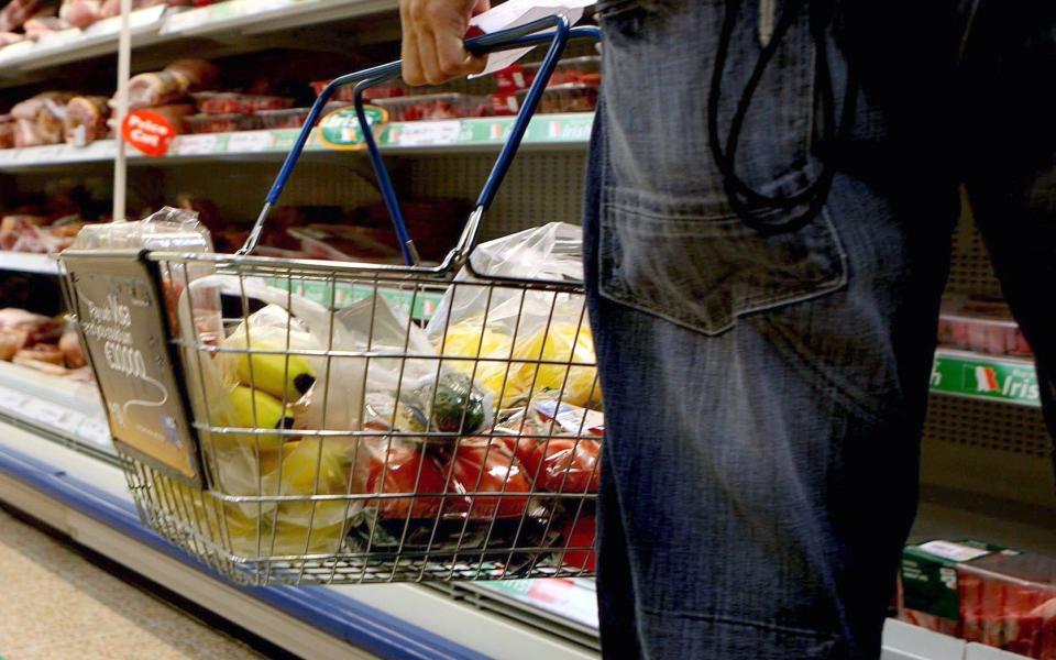 Undated file photo of a person holding a shopping basket in a supermarket. Shop price inflation eased back slightly from record highs last month despite another surge in food prices. Food prices soared 15.7%, the highest on record, in April to continue pressure on consumer finances, according to the latest BRC-NielsenIQ shop price index. Issue date: Tuesday May 2, 2023. PA Photo. See PA story CONSUMER Prices. Photo credit should read: Julien Behal/PA Wire - Julien Behal/PA Wire