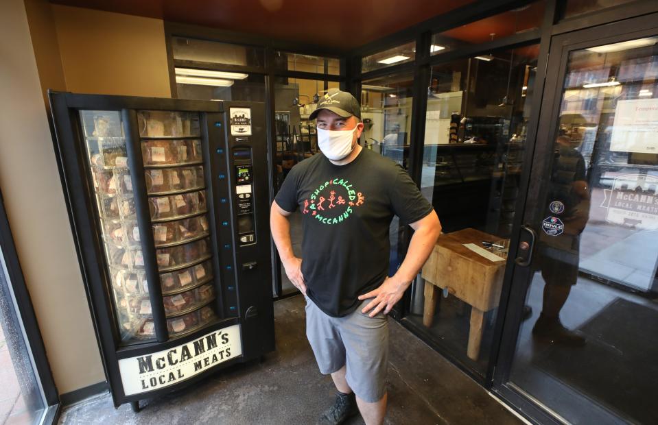 Kevin McCann stands with the new meat vending machine in the lobby of McCann's Local Meats, a butcher shop on South Clinton Avenue.