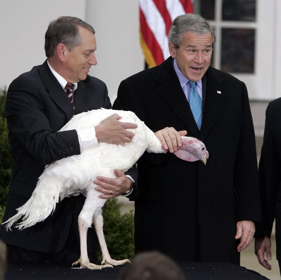 <p>President George W. Bush, right, pets “Flyer” the turkey, held by Lynn Nutt, after giving the bird a Thanksgiving pardon in the Rose Garden of the White House on Wednesday, Nov. 22, 2006. (Photo: Chuck Kennedy/MCT via Getty Images) </p>