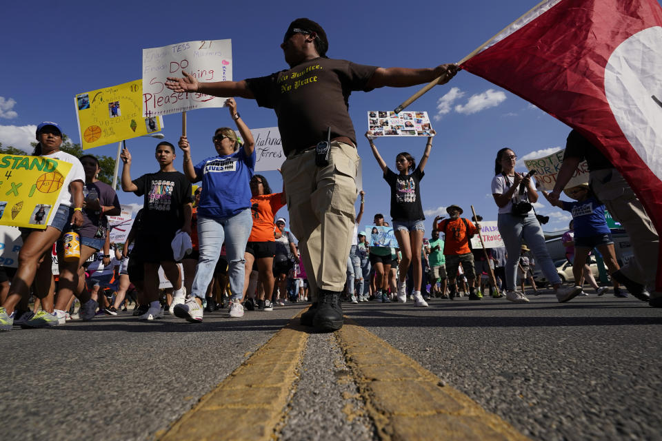 Escorted by the Texas Brown Berets, family and friends of those killed and injured in the school shootings at Robb Elementary take part in a protest march and rally, Sunday, July 10, 2022, in Uvalde, Texas. Families and residents are seeking answers and changes after the tragedy. (AP Photo/Eric Gay)