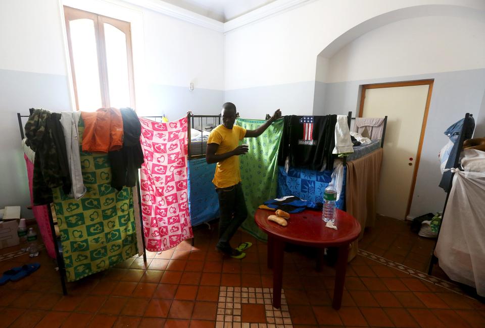 An adolescent migrant stands in his bedroom at an immigration centre in Caltagirone, Sicily March 18, 2015. The number of migrants reaching Italy by sea this year is set to top last year's record of 170,000, the International Organization for Migration (IOM) said. In the past week alone 10,000 have arrived. Another 400 people drowned before making it to Italy's shores, survivors said. The number of minors traveling alone in this mass migration has soared -- underage arrivals to Italy tripled in 2014 from the previous year. Picture taken March 18, 2015. To match Insight ITALY-MIGRANTS/BOYS REUTERS/Alessandro Bianchi