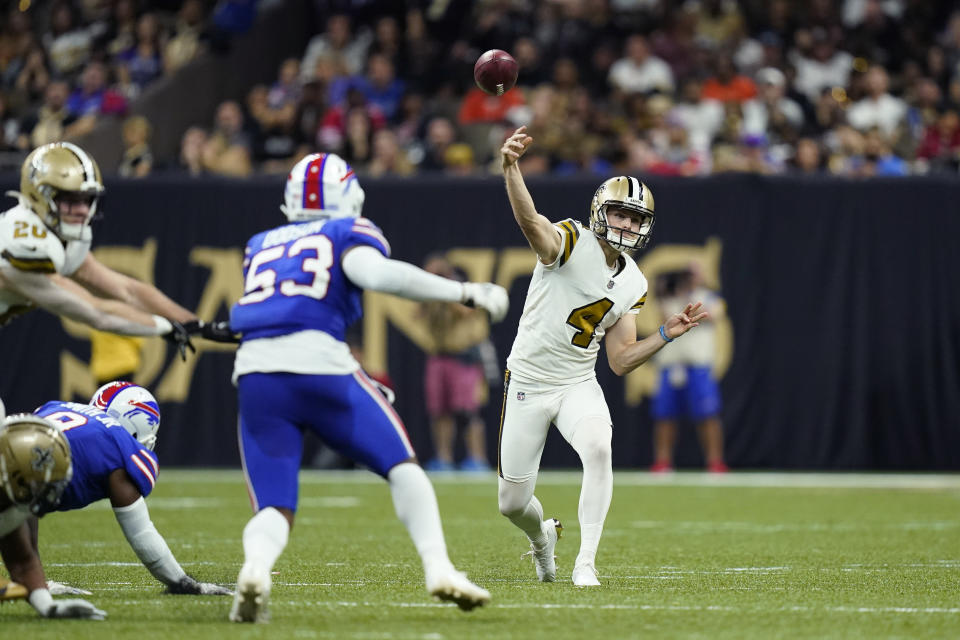 New Orleans Saints punter Blake Gillikin (4) passes on a fake punt in the first half of an NFL football game against the Buffalo Bills in New Orleans, Thursday, Nov. 25, 2021. (AP Photo/Derick Hingle)