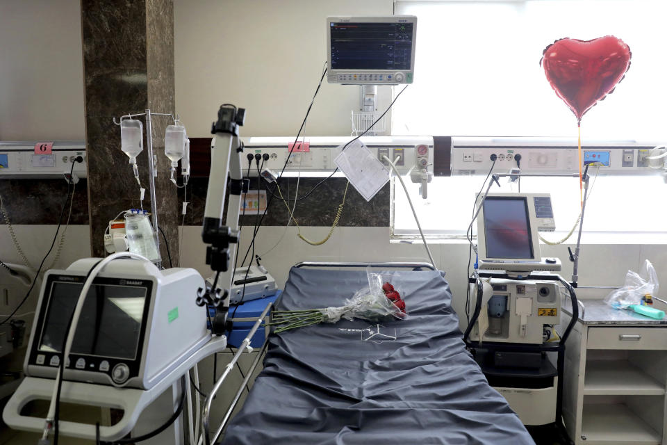 A heart-shaped balloon and a bouquet of roses adorn the bed of a man who died from COVID-19 at the ICU unit of the Shohadaye Tajrish Hospital in Tehran, Iran, Sunday, April 18, 2021. After facing criticism for downplaying the virus last year, authorities have put partial lockdowns and other measures in place to try and slow the coronavirus’ spread, as Iran faces what looks like its worst wave of the coronavirus pandemic yet. (AP Photo/Ebrahim Noroozi)