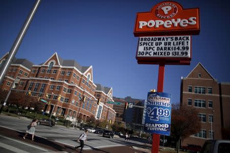 A popeyes restaurant sign is seen on the intersections of Broadway and New Orleans a cross the street from the John Hopkins Hospital in Baltimore, Maryland November 4, 2015. For many who knew Ben Carson in Baltimore, his U.S. presidential candidacy comes as a surprise. Over more than three decades as a Baltimore resident ending in 2013, Carson - now a front-runner in the race for the Republican Party nomination - rarely spoke about his political views. An unassailable local hero, a Johns Hopkins Hospital neurosurgeon, Carson put his wealth to use helping the poor. He established a scholarship program for school children and hosted a banquet each year to honor its recipients. Picture taken November 4, 2015. REUTERS/Carlos Barria - RTS62P7