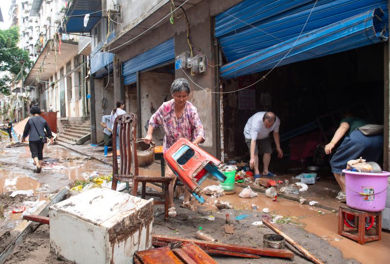 Residents salvage their belongings after heavy rainfall flooded Wanzhou district of Chongqing